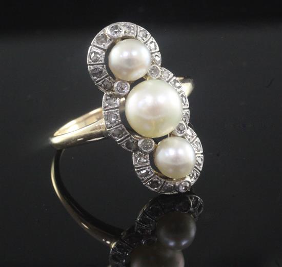 An early 20th century gold, triple cultured pearl and rose cut diamond upfinger ring, size P.